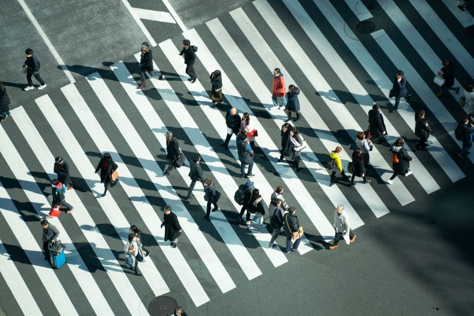 People walking across a crosswalk 