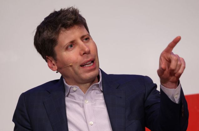 Sam Altman raising his index finger in the air.