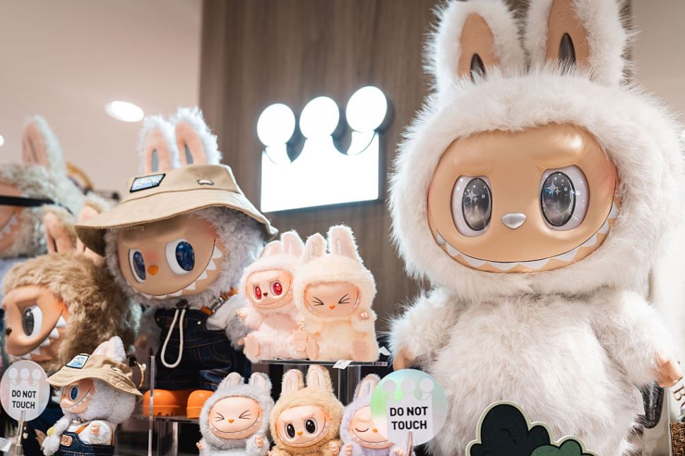 A playful lineup of Labubu figures sits neatly on the shelf