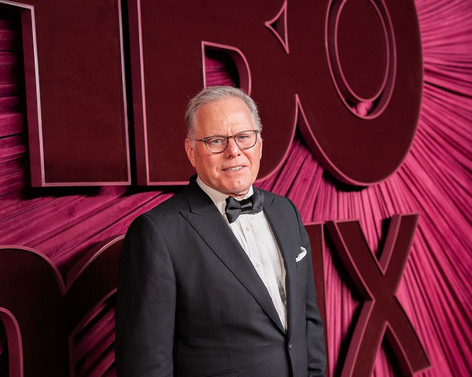 David Zaslav in a texudo against a purple background.