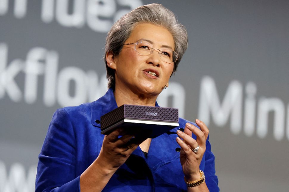 Lisa Su holds up the AMD Ryzen AI Halo, an AI developer platform, during an AMD news conference ahead of CES 2026.