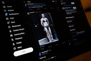 A screen displays a post by Elon Musk on the X app, showing an AI prompt-created image, made with Xai's Grok app, depicting Musk wearing a bikini.