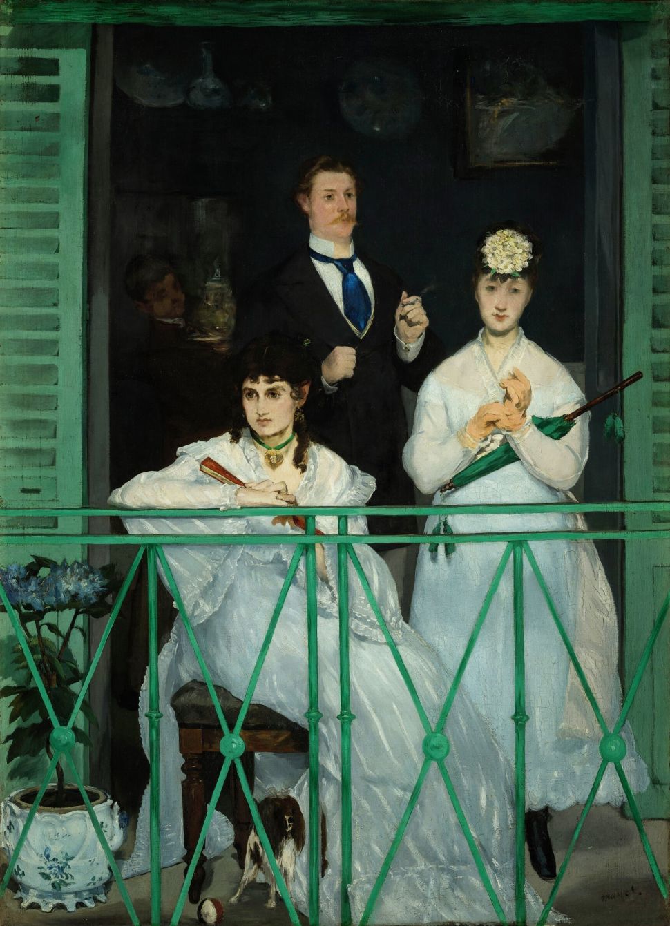 A painting shows two women in white dresses and a man in a dark suit standing on a green balcony, with one woman leaning on the railing, another holding a closed green umbrella, the man behind them smoking, and a small dog at their feet inside a shadowy interior framed by green shutters.